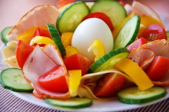 Vegetable salad in the diet menu with eggs and orange for weight loss
